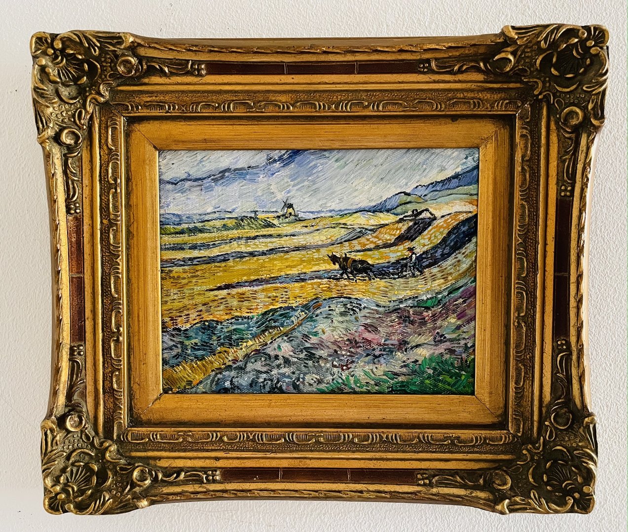 small replica of Van Gogh's Enclosed Field with Ploughman with antique frame